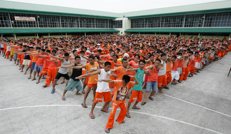 FILE - In this Aug. 8, 2007 file photo, Filipino inmates practice their dance steps for the "Together in Electric Dreams" song, a carefully chosen homage to the inmates' fans, at the Cebu Provincial and Rehabilitation Center in Cebu city, central Philippines. The Filipino inmates whose choreographed "Thriller" dance has attracted 52 million YouTube hits since 2007 are getting their own stories told in a movie. Director Marnie Manicad said the action drama "Dance of the Steel Bars" was shot in the Cebu provincial prison, the same place where the inmates dressed in orange uniforms danced to global fame. Manicad co-directed the movie with Cesar Apolinario. It will be released in June. (AP Photo/Aaron Favila, File)