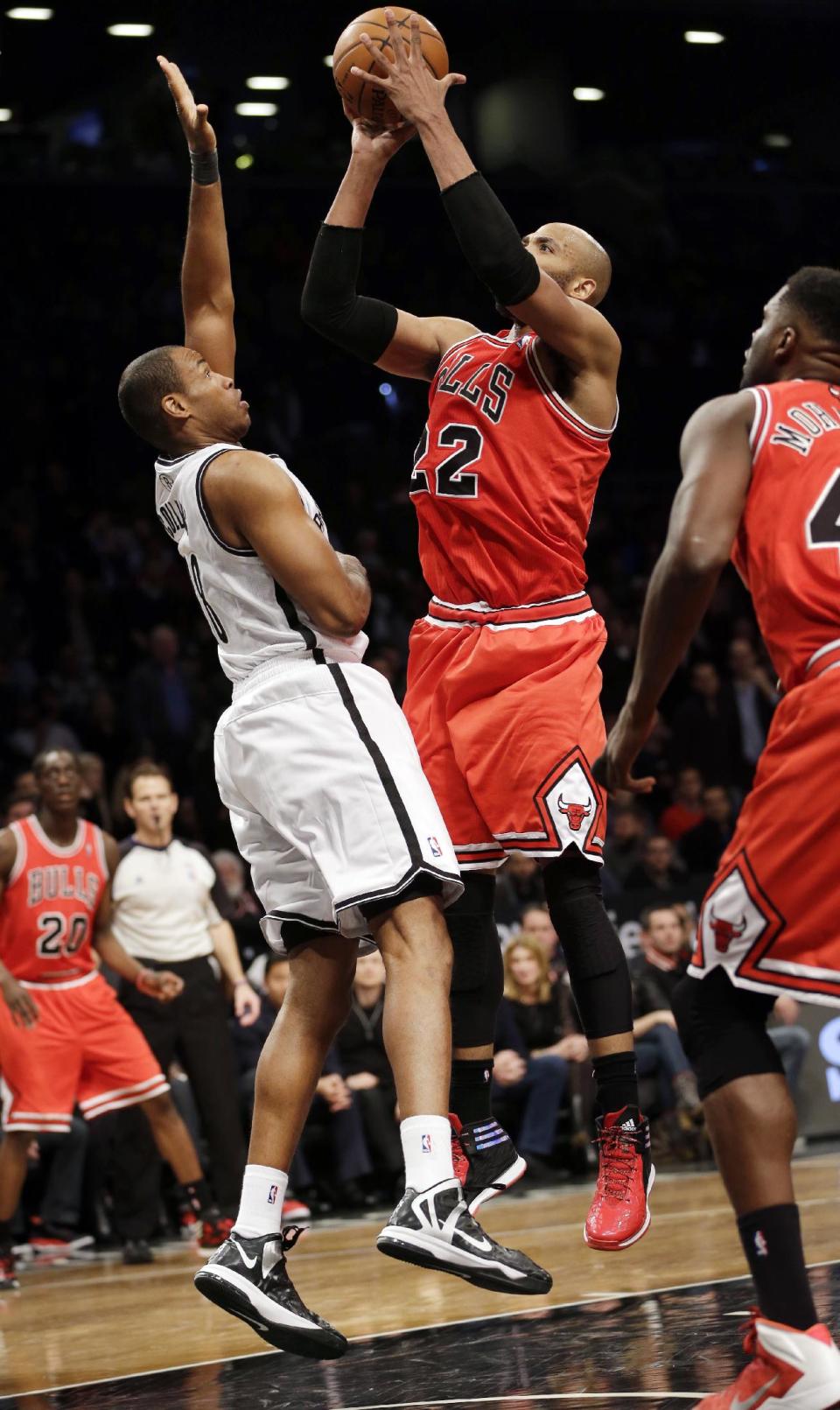 Brooklyn Nets' Jason Collins, left, defends Chicago Bulls' Taj Gibson during the second half of an NBA basketball game Monday, March 3, 2014, in New York. The Nets won 96-80. (AP Photo/Seth Wenig)