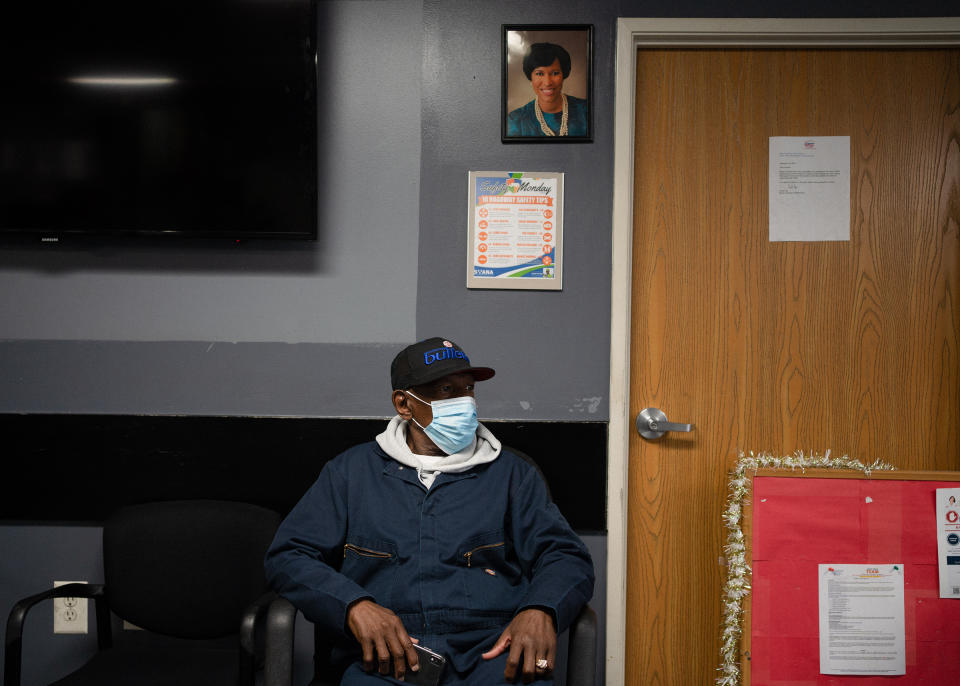 Sanitation worker Vincent Walker sits below a portrait of Mayor Muriel Bowser inside the Department of Public Works Solid Waste Collections Division. | Nate Palmer for TIME