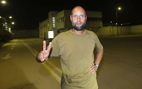 Saif al-Islam Gaddafi in August 2011 at his father's residential complex in Tripoli - Credit: AFP