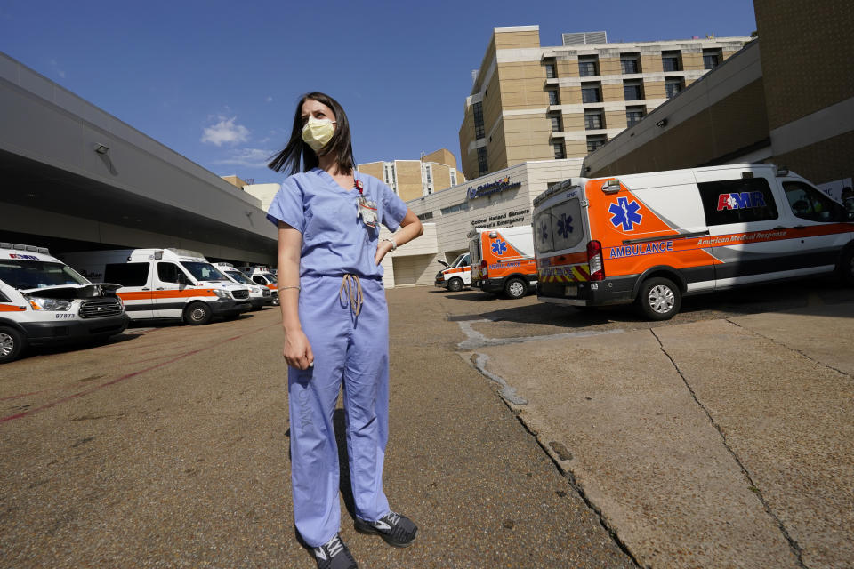 Anne Sinclair, a pediatric emergency room nurse at the University of Mississippi Medical Center, in Jackson, stands in the middle of the filled ambulance bay and wonders why some incoming patients and their parents have to be reminded to wear masks when they come to the hospital, Wednesday, Aug. 25, 2021. A mother of two young children, Sinclair is tired of the covid misinformation she deals with having seen children in her unit die of the virus. (AP Photo/Rogelio V. Solis)
