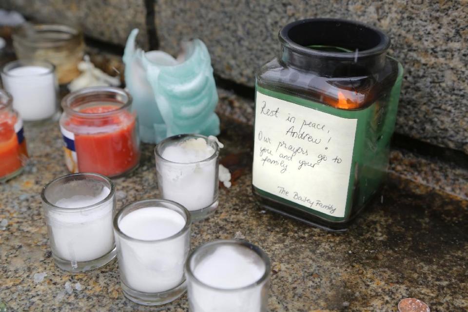 Candles, several still burning, along with flowers are placed on the steps of Hovde Hall in memorial to slain engineering student Andrew Boldt Wednesday, Jan. 22, 2014, on the campus of Purdue University in West Lafayette, Ind. Boldt was shot and killed Tuesday at the Electrical Engineering building. Cody Cousins, a student, has been charged in the shooting. (AP Photo/Journal & Courier, John Terhune)