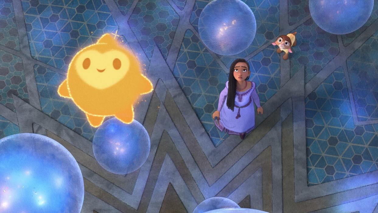 Asha looks on as Star helps track down her grandfather's Wish in the new animated movie. (Disney)