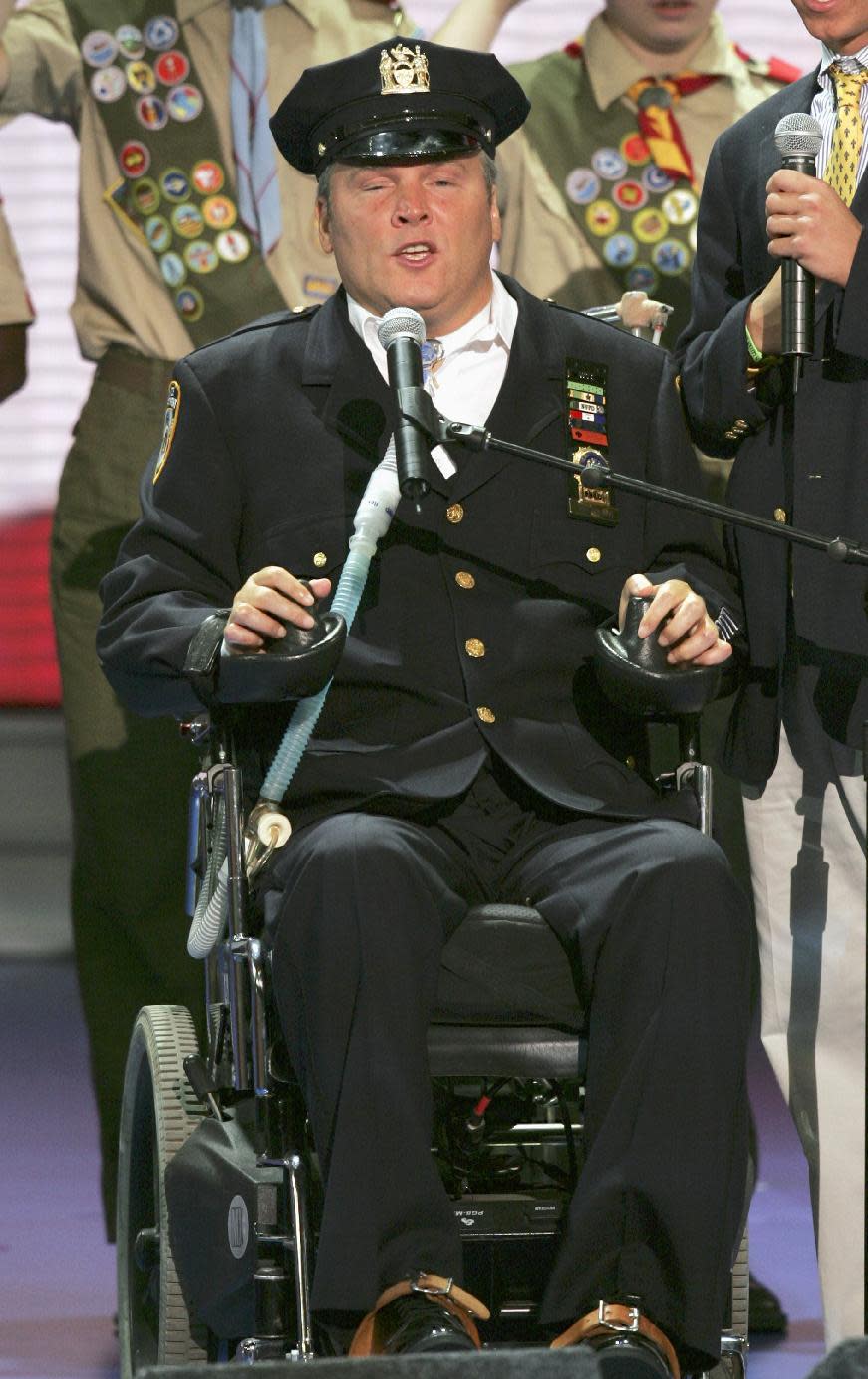 FILE- In this Aug. 30, 2004 file photo, New York Police Officer Steven McDonald recites the Pledge of Allegiance before the morning session of the Republican National Convention at Madison Square Garden in New York. On Tuesday, Jan. 10, 2017, officials said McDonald, who was paralyzed by a bullet and became an international voice for peace after he publicly forgave the gunman, died at the age of 59. (AP Photo/J. Scott Applewhite, File)