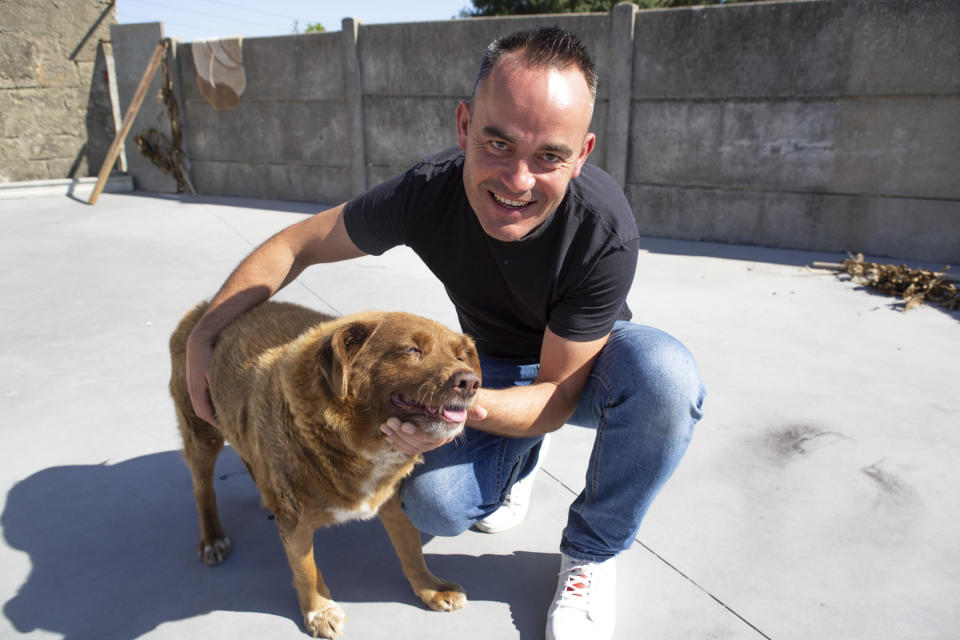 Leonel Costa with his 31-year-old dog Bobi in Leiria, Portugal, on July 2, 2023.  / Credit: Luis Boza/Anadolu Agency via Getty Images