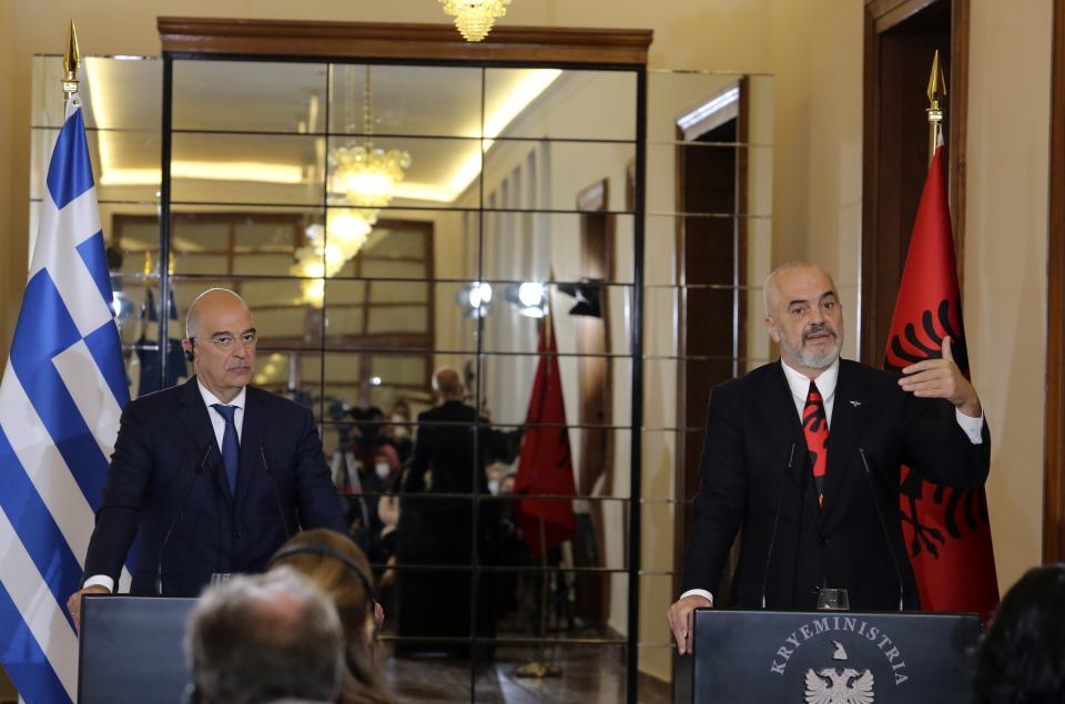 Albanian Prime Minister Edi Rama, right, makes a statement with the Greek Foreign Minister Nikos Dendias after their meeting in Tirana, Tuesday, Oct. 20, 2020. Bilateral issues and maritime border delimitation in the Ionian Sea were the main topics of their discussion. (AP Photo/Hektor Pustina)