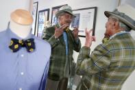 Domenico "Mimmo" Spano checks his look in a mirror at his atelier