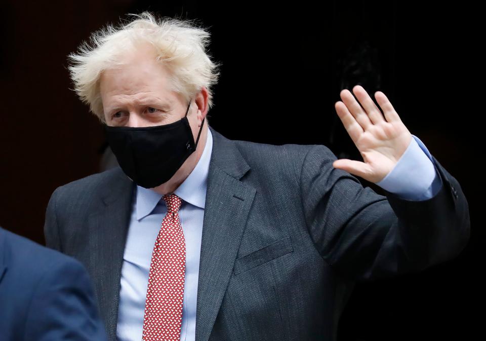 Britain's Prime Minister Boris Johnson wears a face mask or covering due to the COVID-19 pandemic, as he leaves 10 Downing Street in central London on September 30, 2020 to attend the weekly Prime Minister's Questions (PMQs) session in the House of Commons. (Photo by Tolga AKMEN / AFP) (Photo by TOLGA AKMEN/AFP via Getty Images)