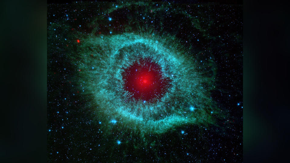 This infrared image from NASA's Spitzer Space Telescope shows the Helix nebula, a cosmic starlet often photographed by amateur astronomers for its vivid colours and resemblance to a giant eye. An optimised and digitally enhanced version of a NASA/ ESA image.