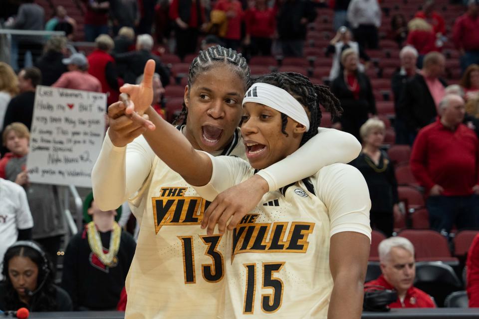 Louisville guard Merissah Russell (13) and guard Nina Rickards celebrate their 73-66 win over Notre Dame on Thursday at the KFC Yum! Center.