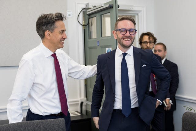 Energy Secretary Ed Miliband welcoming Chris Stark as two men follow behind