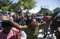 Demonstrators march demanding peace and security in La Plaine neighborhood of Port-au-Prince, Haiti, Friday, May 6, 2022. Escalating gang violence has prompted Haitians to organize protests to demand safer neighborhoods. (AP Photo/Odelyn Joseph)