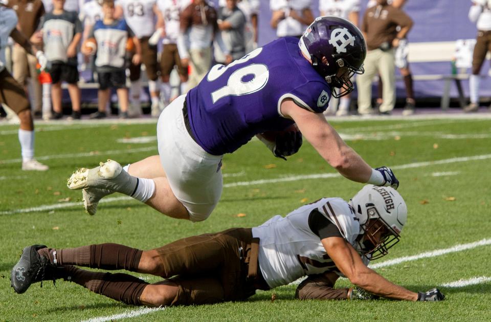 Holy Cross's Matthew Kane is tackled by Lehigh’s DJ Lawrence on his way to a first down in the first quarter.