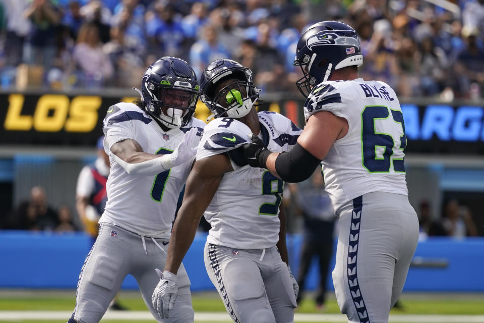 Seattle Seahawks running back Kenneth Walker III (9) celebrates with wide receiver Dee Eskridge (1) guard Austin Blythe (63) after scoring a touchdown during the first half of an NFL football game against the Los Angeles Chargers Sunday, Oct. 23, 2022, in Inglewood, Calif. (AP Photo/Marcio Jose Sanchez)