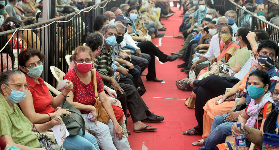 MUMBAI, INDIA  APRIL 27: People wait in a queue to get vaccinated against Covid-19 at BKC Jumbo Covid-19 Vaccination Centre, on April 27, 2021 in Mumbai, India. (Photo by Satish Bate/Hindustan Times via Getty Images)