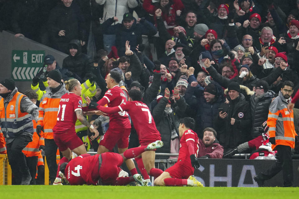 Liverpool players celebrate after Liverpool's Trent Alexander-Arnold scored his side's fourth goal during the English Premier League soccer match between Liverpool and Fulham at the Anfield stadium in Liverpool, England, Sunday, Dec. 3, 2023. (AP Photo/Jon Super)