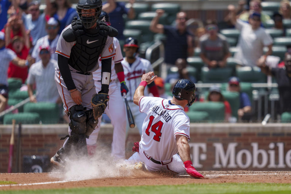 Atlanta Braves Sam Hilliard (14) slides into home base at the bottom of the 10th inning of a baseball game against the Baltimore Orioles on Sunday, May 7, 2023, in Atlanta. (AP Photo/Erik Rank)