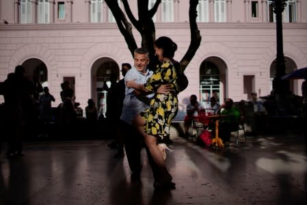 People dance tango during a weekly Sunday milonga on Havana's Paseo del Prado promenade