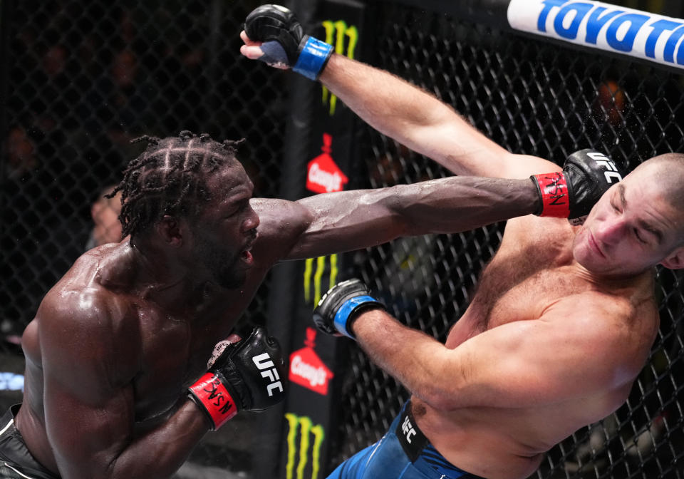 LAS VEGAS, NEVADA - DECEMBER 17: (L-R) Jared Cannonier punches Sean Strickland in a middleweight fight during the UFC Fight Night event at UFC APEX on December 17, 2022 in Las Vegas, Nevada. (Photo by Chris Unger/Zuffa LLC)