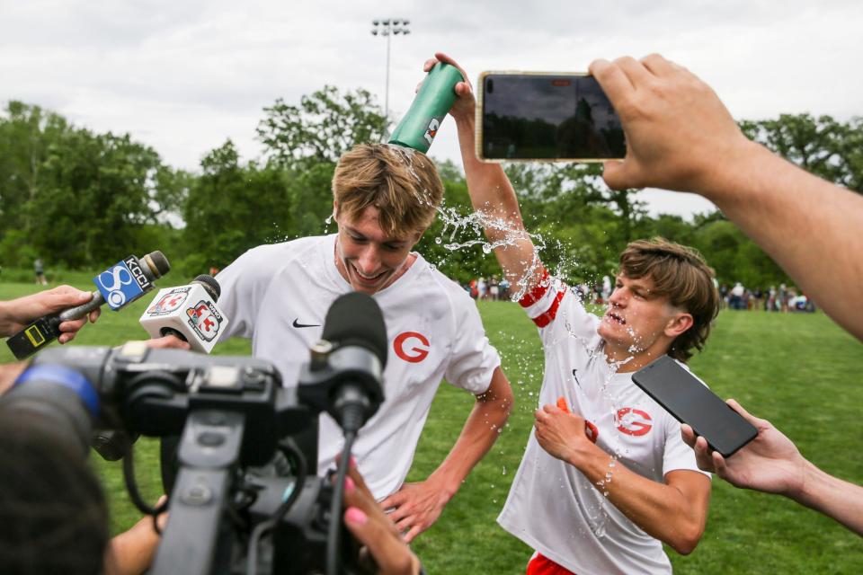 Gilbert's Evan Weary (9) pours water on Gilbert's Alex Ruba (22) after the Tigers beat Marion during the Class 2A Boys State Soccer Tournament quarterfinal at the Cownie Soccer Complex Wednesday, June 1, 2022 in Des Moines.