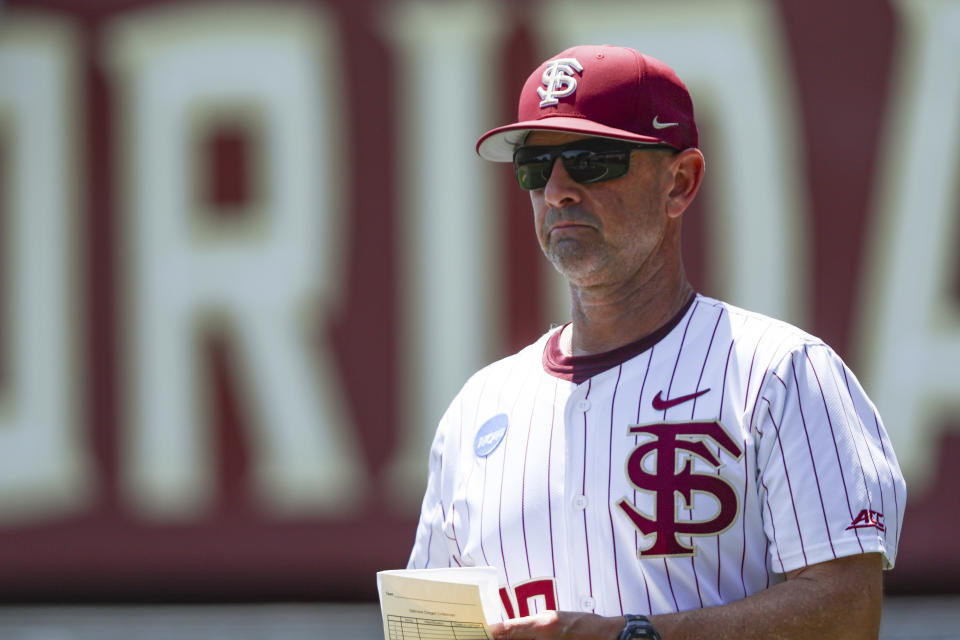 Florida State head coach Link Jarrett meets with officials before an NCAA college regional baseball game against Stetson on Friday, May 31, 2024 in Tallahassee, Fla. (AP Photo/Gary McCullough)