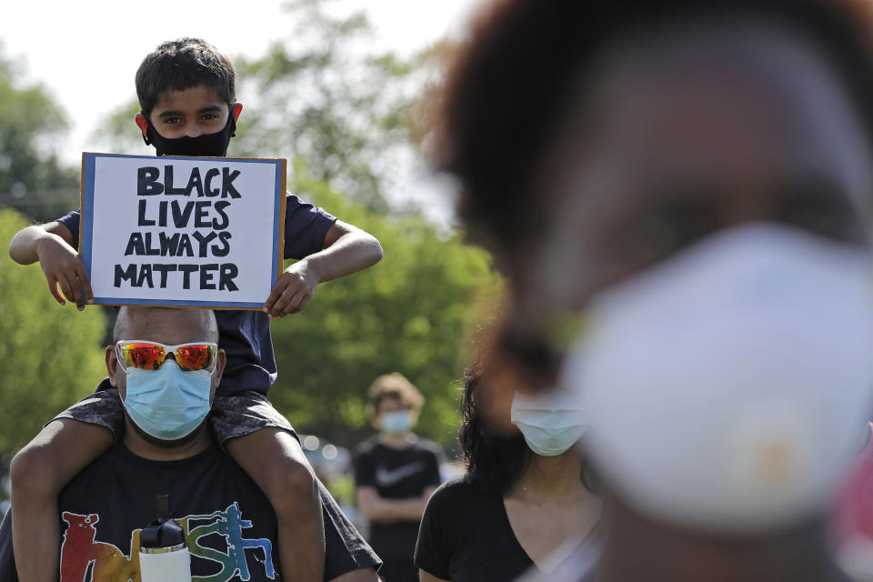 Demonstrators gather to protest for George Floyd during a Black Lives Matter protest at the Buffalo Grove park District's Spray 'N Play in Buffalo Grove, Ill., Thursday, June 4, 2020. Floyd, a black man, died after he was restrained in custody by the Minneapolis police on May 25. (AP Photo/Nam Y. Huh)