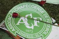 <p>A red rose sits on top of the Chapecoense soccer team logo outside the Arena Conda stadium, where team fans are gathering in Chapeco, Brazil, Tuesday, Nov. 29, 2016. A chartered plane that was carrying the Brazilian soccer team Chapecoense to the biggest match of its history crashed into a Colombian hillside and broke into pieces, Colombian officials said Tuesday. (AP Photo/Andre Penner) </p>