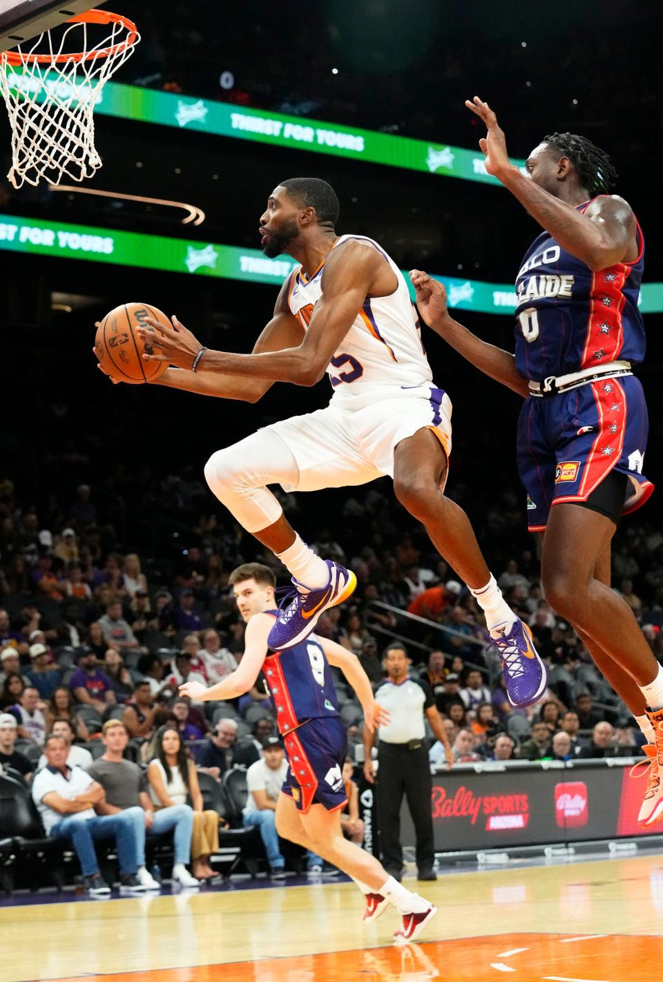 Phoenix Suns forward Mikal Bridges (25) drives to the basket past Adelaide 36ers guard Robert Franks (0) at Footprint Center in Phoenix on Oct. 2, 2022.