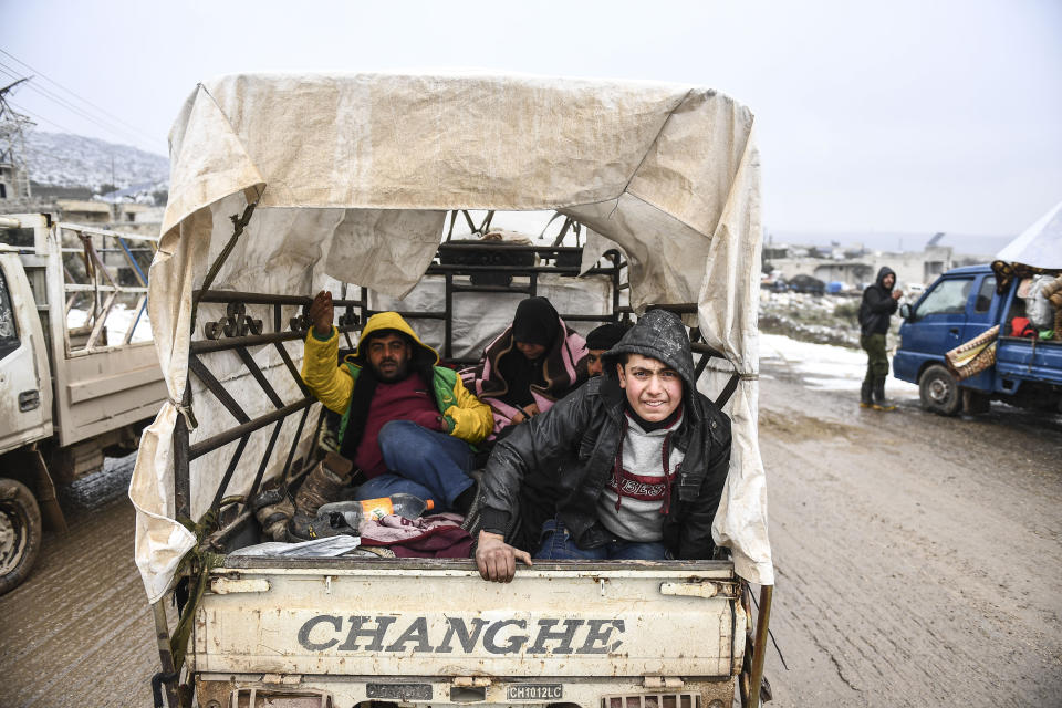 Syrian civilians flee from Idlib in rain toward the north to find safety inside Syria near the border with Turkey, Thursday, Feb. 13, 2020. Syrian troops are waging an offensive in the last rebel stronghold according to news reports by a Turkish news agency.( AP Photo)