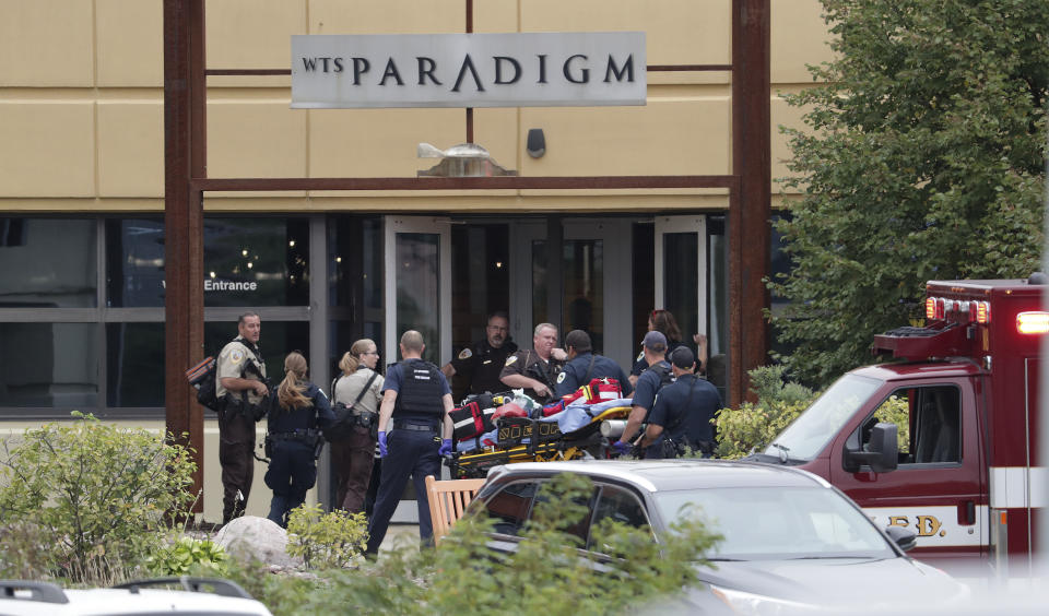 Emergency personnel arrive on the scene of a shooting at a software company in Middleton, Wis., Wednesday, Sept. 19, 2018. Four people were shot and wounded during the shooting in the suburb of Madison, according to a city administrator. (Steve Apps/Wisconsin State Journal via AP)