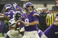 Minnesota Vikings quarterback Kirk Cousins (8) throws under pressure from Seattle Seahawks linebacker Jordyn Brooks (56) in the first half of an NFL football game in Minneapolis, Sunday, Sept. 26, 2021. (AP Photo/Jim Mone)