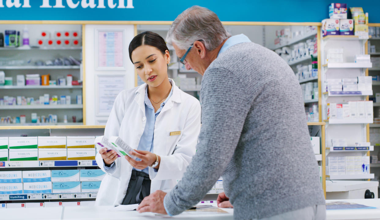 Shot of a young pharmacist assisting a customer in a chemist