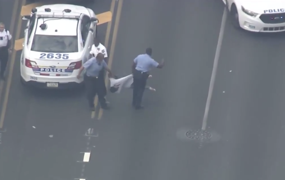 Aerial footage shows two officers restraining a man. It is believed shots can still be heard in the area. Source: Twitter