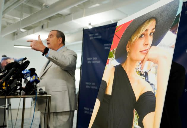 Brian Panish, an attorney for the family of the late cinematographer Halyna Hutchins, speaks next to a portrait of Hutchins at a Feb. 15 news conference in Los Angeles. Hutchins' family is suing Alec Baldwin and the 