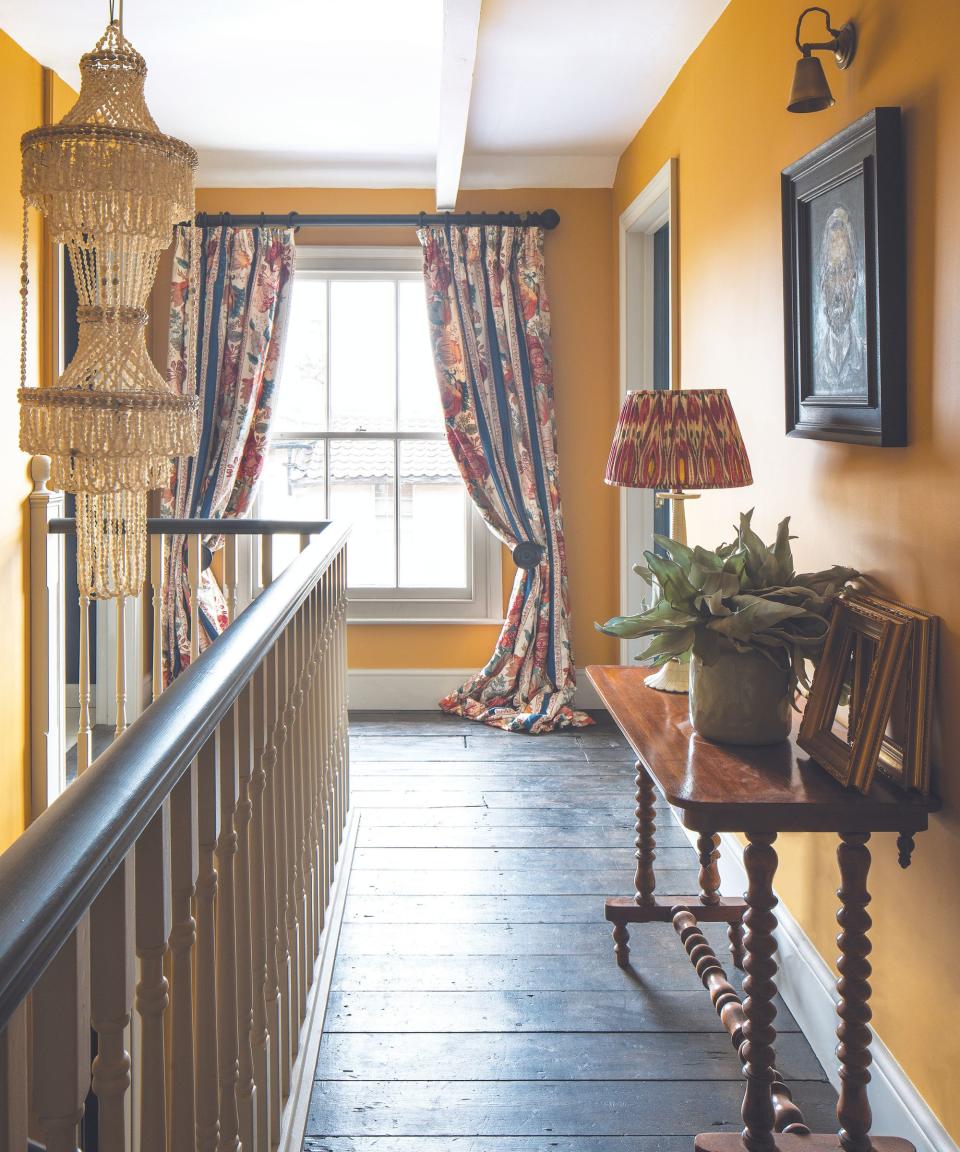 Yellow walls, rope light, black wooden floor