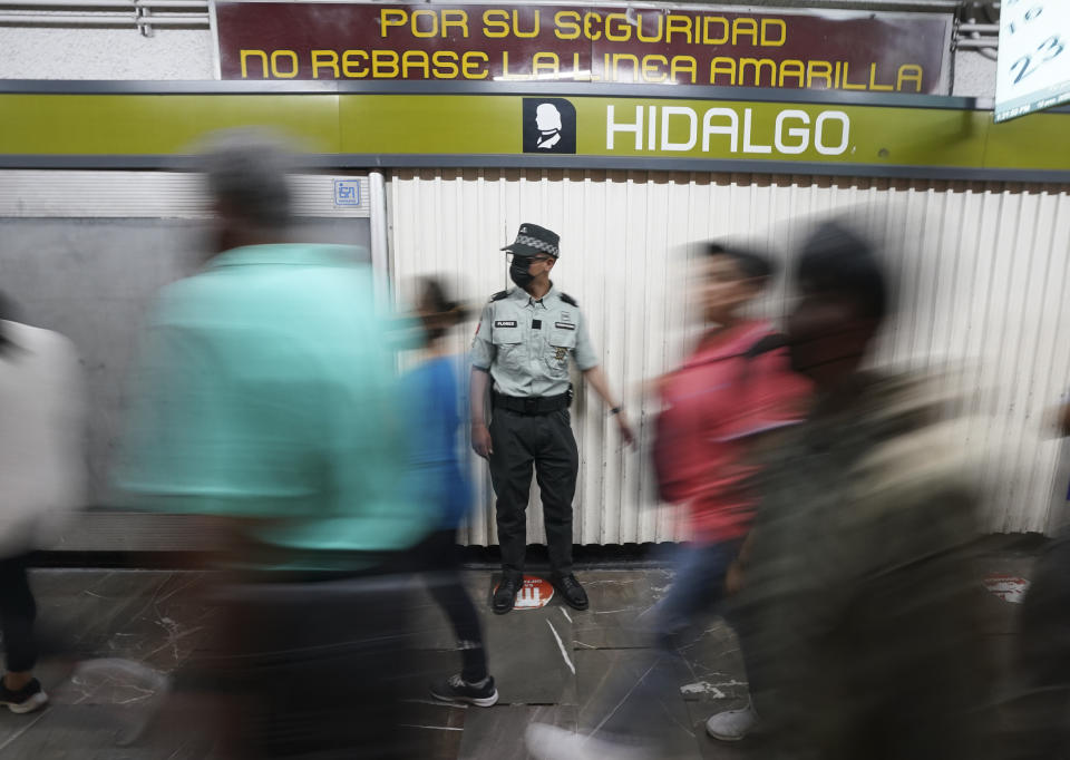 A member of the Mexican National Guard stands on guard at a subway station in Mexico City, Thursday, Jan. 12, 2023. The mayor of Mexico City says that more the 6 thousand National Guard officers will be posted in the city's subway system after a series of accidents that officials say could be due to sabotage. (AP Photo/Fernando Llano)
