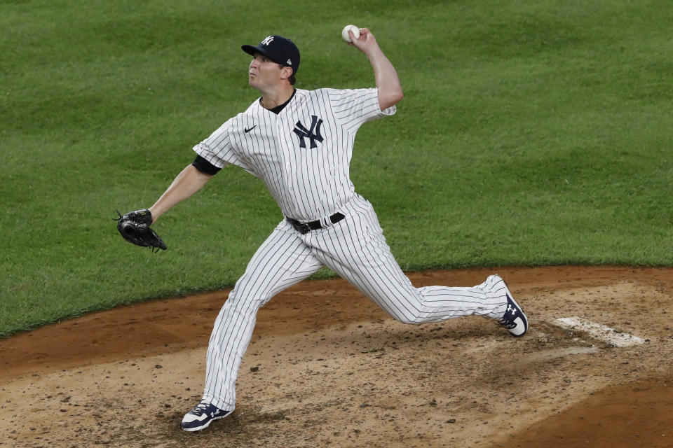 FILE - In this Aug. 3, 2020, file photo, New York Yankees relief pitcher Zack Britton winds up during the ninth inning of the team's baseball game against the Philadelphia Phillies at Yankee Stadium in New York. The Yankees plan to plan to exercise two option years on Britton worth $27 million and to decline options on outfielder Brett Gardner and pitcher J.A. Happ. The decisions were disclosed by a person familiar with the team’s decisions who spoke on the condition of anonymity Thursday, Oct. 29, because they had not been announced. (AP Photo/Kathy Willens, File)