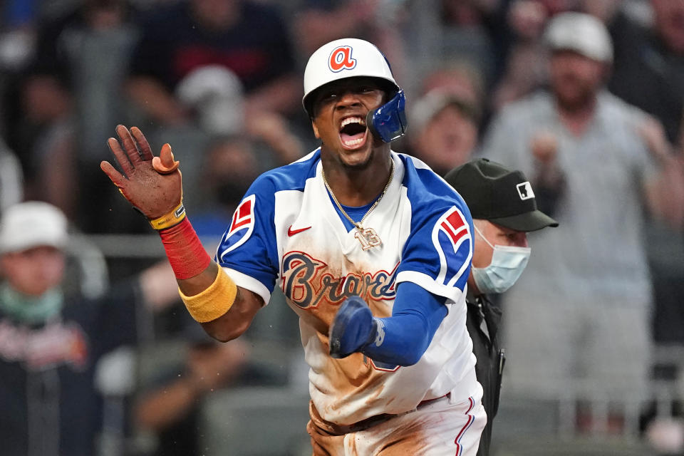 Atlanta Braves' Ronald Acuna Jr. (13) reacts after scoring on an Ozzie Albies sacrifice fly in the third inning of a baseball game against the Miami Marlins, Monday, April 12, 2021, in Atlanta. (AP Photo/John Bazemore)