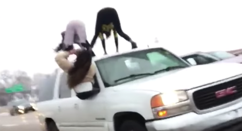 Women twerk upon the hood of an SUV in St. Louis for reasons unknown. (Photo: YouTube)