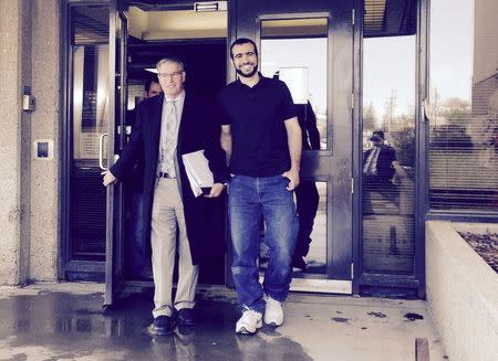 Omar Khadr (R) leaves a courthouse with his lawyer Dennis Edney in this handout photo provided by Nathan Whitling in Edmonton, Alberta May 7, 2015. REUTERS/Nathan Whitling/Handout via Reuters