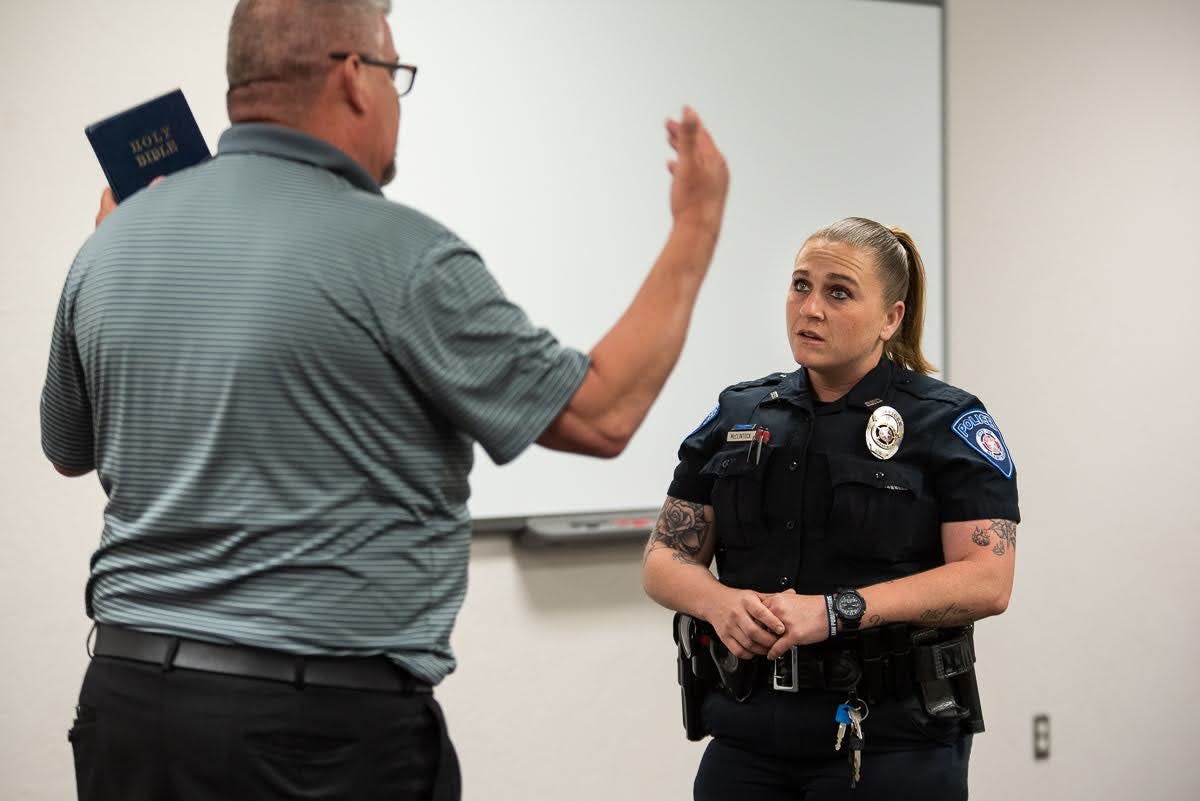 During a role-playing training exercise, Blanchard police officer Tawny McClintock assesses a man who is preaching loudly outside of a business, played by Norman Police Lt. Cary Bryant. These scenarios are the culmination of a 40-hour crisis intervention training that teaches law enforcement officers how to recognize and respond to mental health crises.