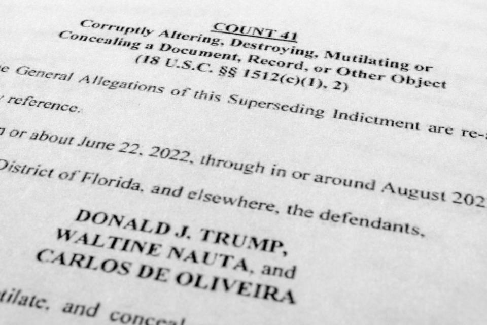 FILE - The updated indictment against former President Donald Trump, Walt Nauta and Carlos De Oliveira is photographed Thursday, July 27, 2023. A witness in the criminal case against Donald Trump over the hoarding of classified documents retracted “prior false testimony” after switching lawyers last month and provided new information that implicated the former president, the Justice Department said Tuesday, Aug. 22. (AP Photo/Jon Elswick, File)