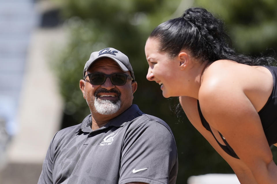 California track and field coach Mohamad Saatara, left, talks with Caisa-Marie Lindfors, right, during a practice in Berkeley, Calif., Thursday, May 2, 2024. The man known as Coach Mo hopes to have as many as 15 of his athletes at the Paris Olympics this summer representing multiple countries. (AP Photo/Jeff Chiu)