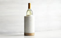 <p>This mango wood and white marble wine cooler keeps a bottle cool for hours—and will look right at home on anyone’s kitchen table or counter.</p> <p>To buy: <a rel="nofollow noopener" href="http://www.anrdoezrs.net/links/7876402/type/dlg/sid/TLTRVggG250Under%2450EO1Sep/http://www.crateandbarrel.com/wood-and-marble-wine-cooler/s677465" target="_blank" data-ylk="slk:Crate & Barrel;elm:context_link;itc:0;sec:content-canvas" class="link ">Crate & Barrel</a>, $39.95</p>