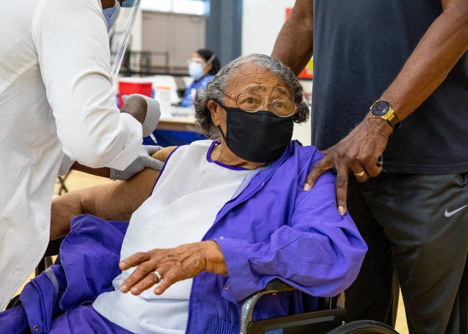 Former educator Nancy Dawkins, 97, who worked for Miami-Dade County Public Schools for over 30 years, reacts to receiving a vaccine at the new FEMA-supported, state-run COVID-19 vaccine satellite site inside the Samuel K. Johnson Youth Center at Charles Hadley Park in Liberty City, Florida, on Friday, March, 19, 2021.