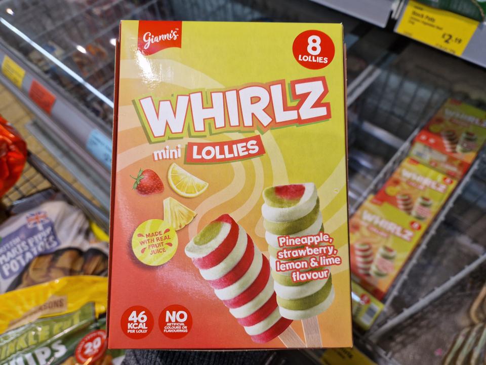 The writer holds a box of Whirlz lollipops