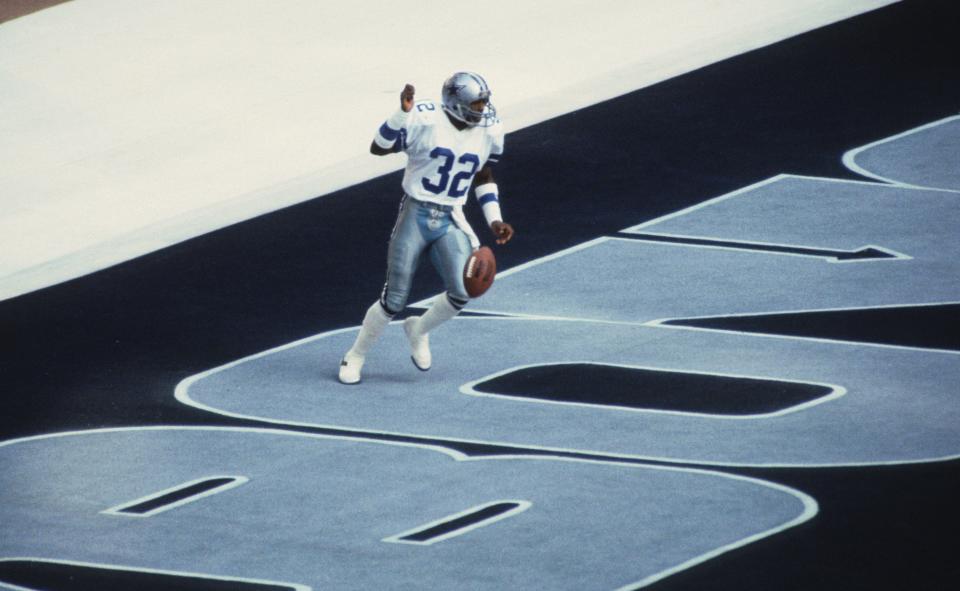 Jan 16, 1983; Irving, TX, USA; FILE PHOTO; Dallas Cowboys defensive back Dennis Thurman (32) scores a touchdown after an interception against the Green Bay Packers during the 1982 NFC Divisional Playoff Game at Texas Stadium. Mandatory Credit: Manny Rubio-USA TODAY NETWORK