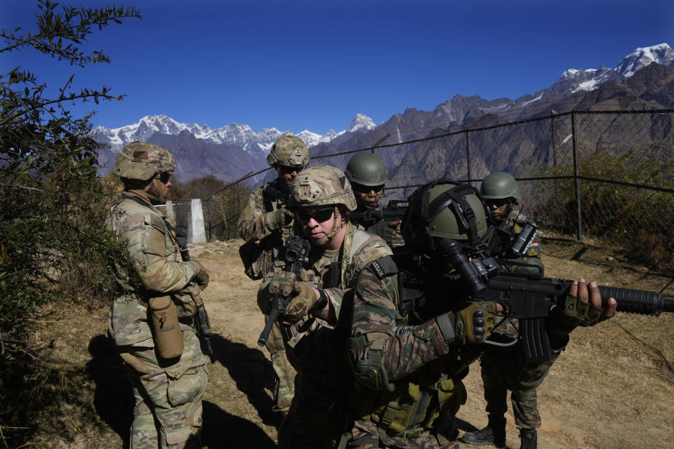 US army soldiers of 2nd Brigade of the 11th Airborne Division with Indian army soldiers participate in a target kill exercise during Indo-US joint exercise or "Yudh Abhyas, in Auli, in the Indian state of Uttarakhand, Tuesday, Nov. 29, 2022. India’s defence ministry statement said the joint exercise is conducted annually with the aim of exchanging best practices, tactics, techniques and procedures between the armies of the two nations. The training schedule focuses on employment of an integrated battle group under Chapter VII of the UN Mandate. The schedule will include all operations related to peace keeping & peace enforcement. (AP Photo/Manish Swarup)