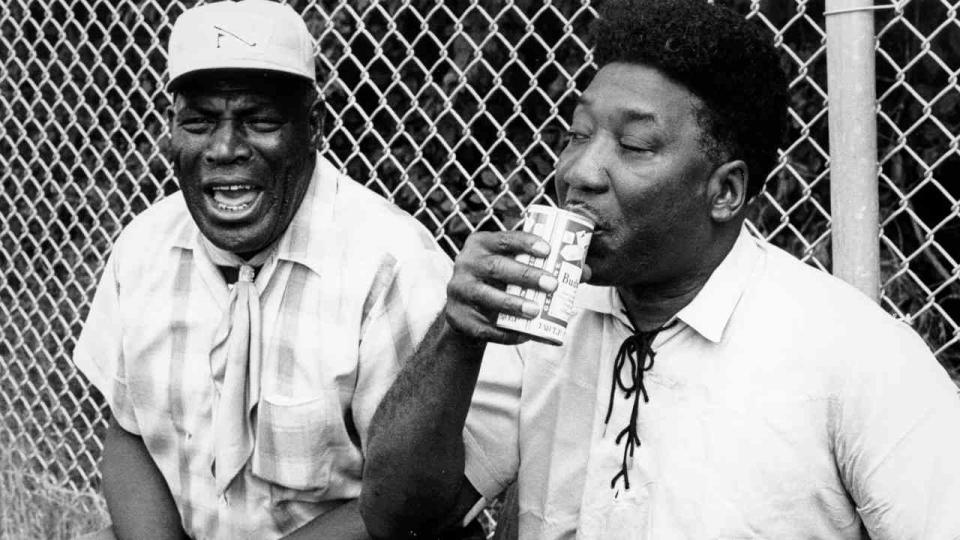 Blues musicians Muddy Waters and Howlin’ Wolf sharing a beer backstage at a festival in 1969