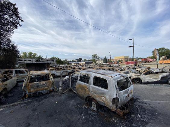 Cars burned during recent protests in Kenosha, Wisconsin. (Richard Hall / The Independent )